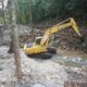 Excavator ADHI sedang melakukan normalisasi sungai Sumbar di area terdampak banjir untuk mempercepat pemulihan infrastruktur.